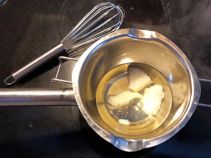 Shea butter and coconut oil being combined in a bowl.
