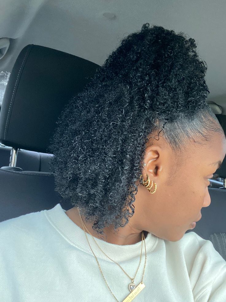 Natural 4C hair styled in a curly half-up hairstyle