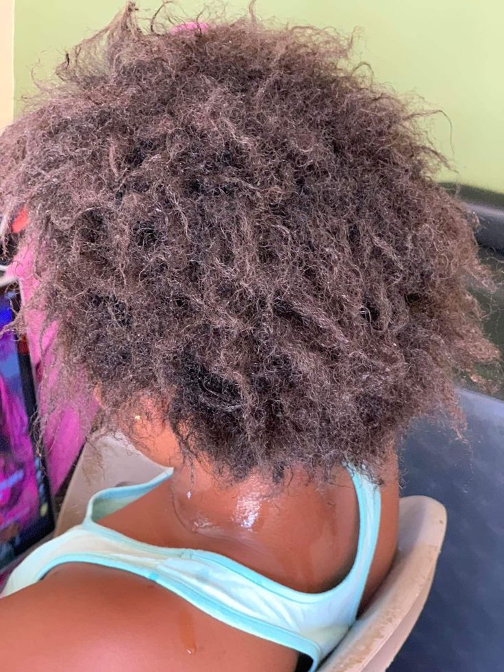 Close-up of dry, brittle natural hair showing signs of damage.