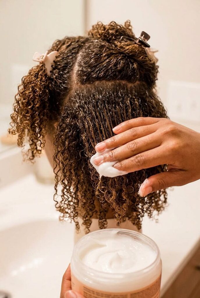 a woman deep conditioning her hair before starting locs on 4c hair