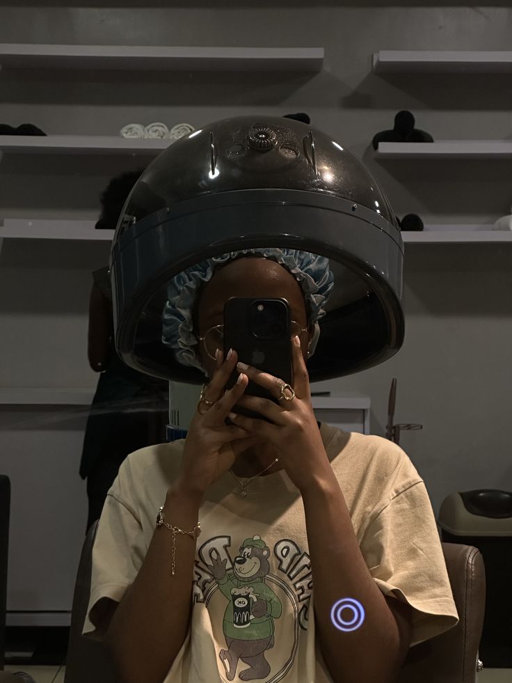 woman sitting under hair heater so conditioner has enough time to work