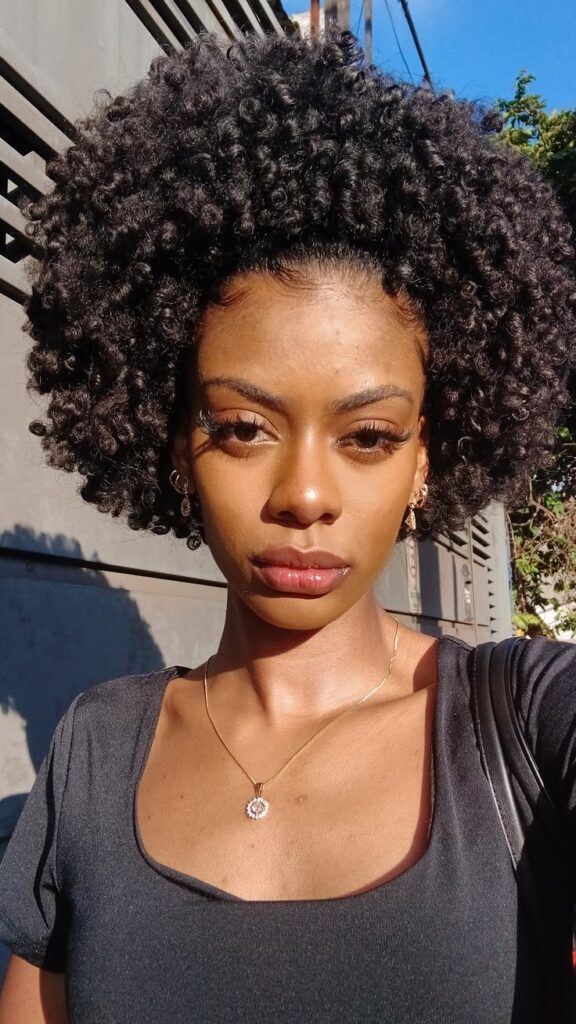 Woman wearing a cute defined mini afro with natural 4C coils