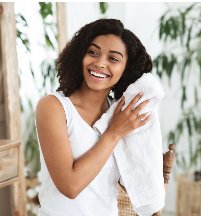 Natural 4C hair being gently dried with a soft microfiber towel