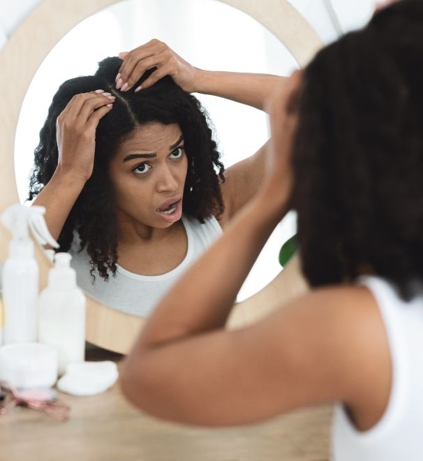 woman examining her dry hair