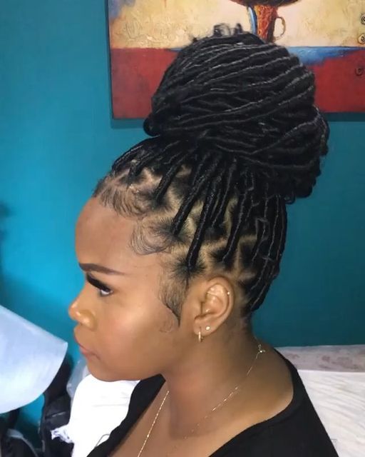 Faux locs styled into a bun