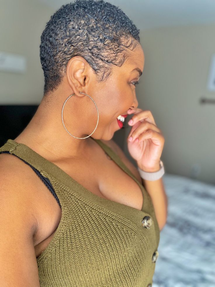 Black woman smiling after a fresh big chop on natural 4C hair.
