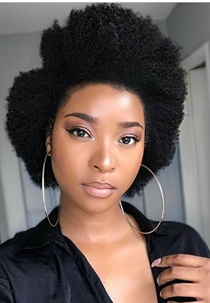 Black woman wearing a beautiful natural 4C hairstyle with healthy full edges