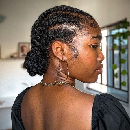 Black woman wearing a loose gentle protective natural hairstyle with healthy edges