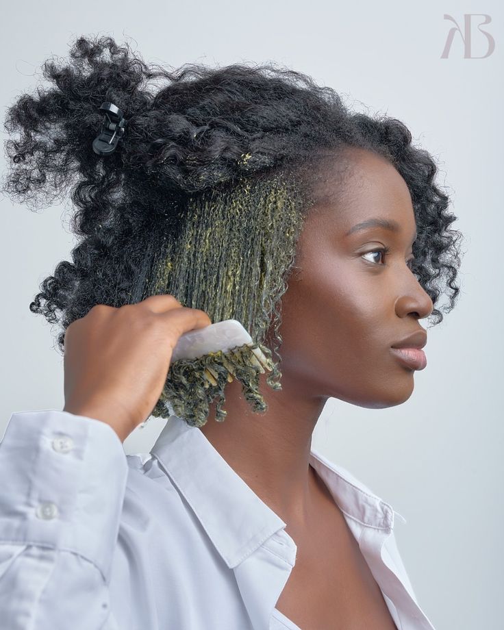 a woman gently detangling hair with hair mask
