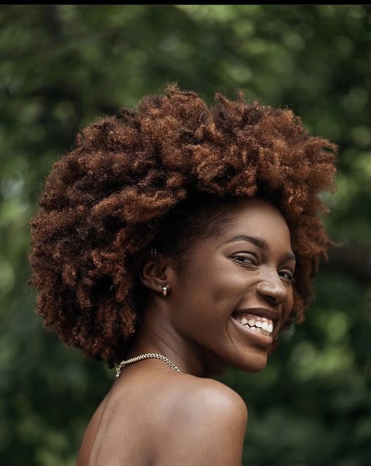 a smiley woman with beautiful afro hair