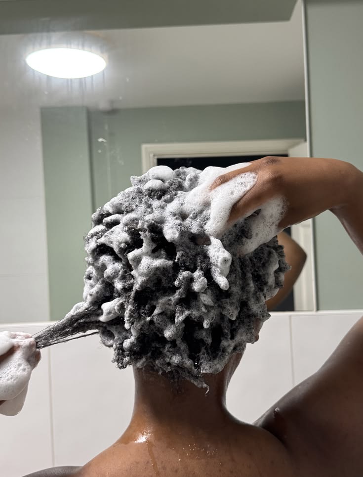 woman washing her hair with clarifying shampoo