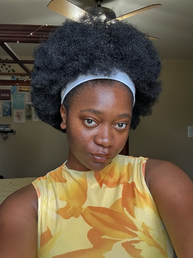 Natural 4C afro styled with a headband