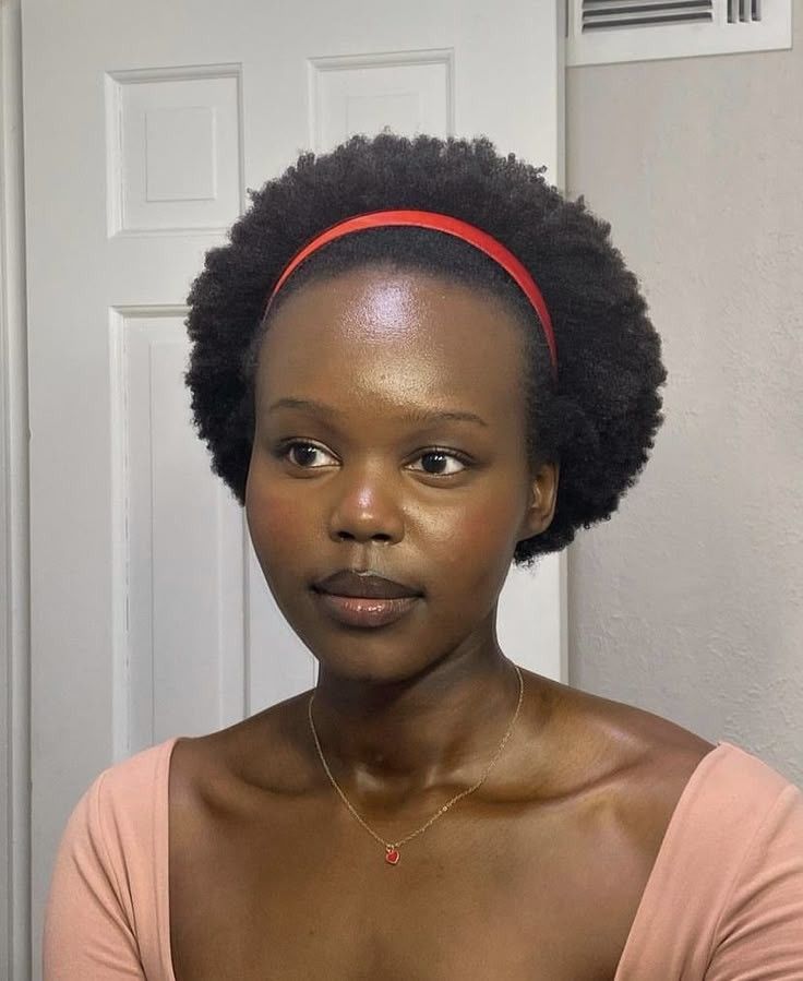 Natural 4C afro styled with a headband