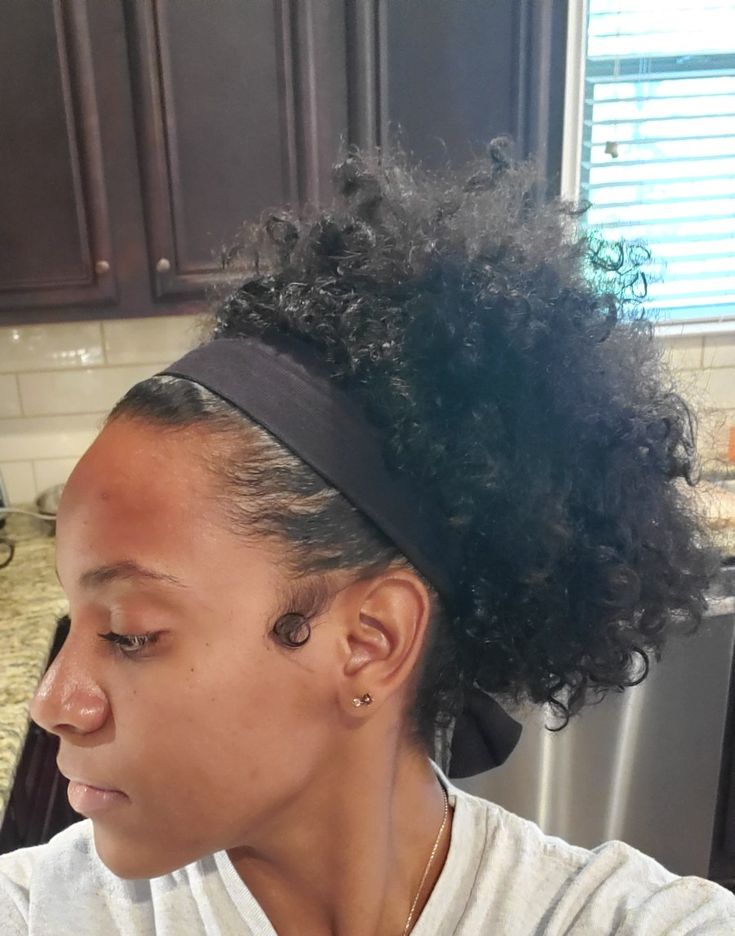 Natural 4C hair styled with a headband updo