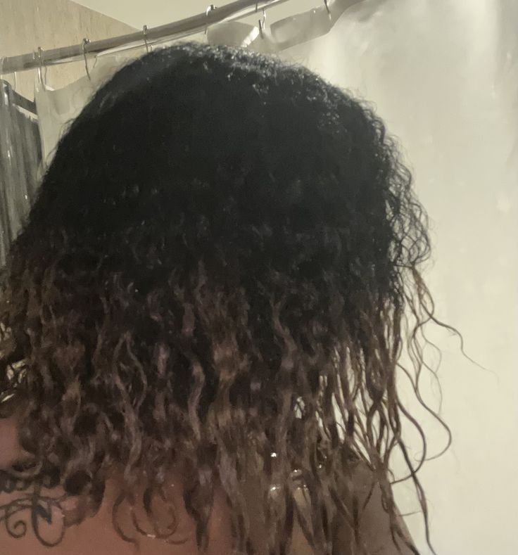 Close-up of Black woman's heat damaged 4C hair, dry weakened ends and uneven curl pattern