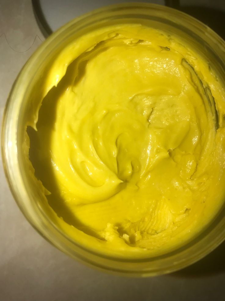 A light, whipped mango butter hair cream in a small jar.