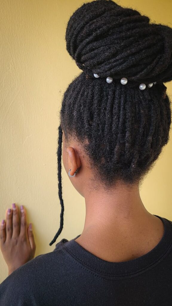 Locs styled into an elegant bun