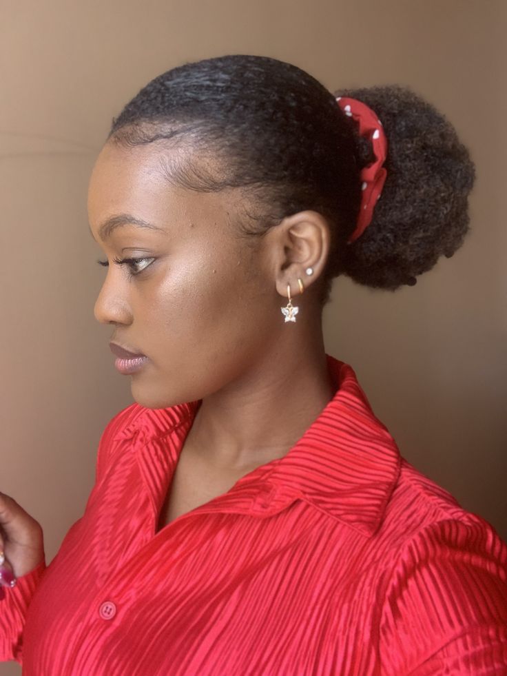 Natural 4C hair styled into a cute low afro puff