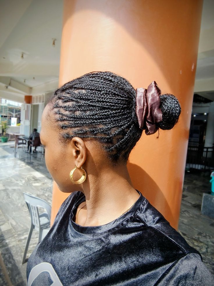  Braids styled into a low bun on natural 4C hair