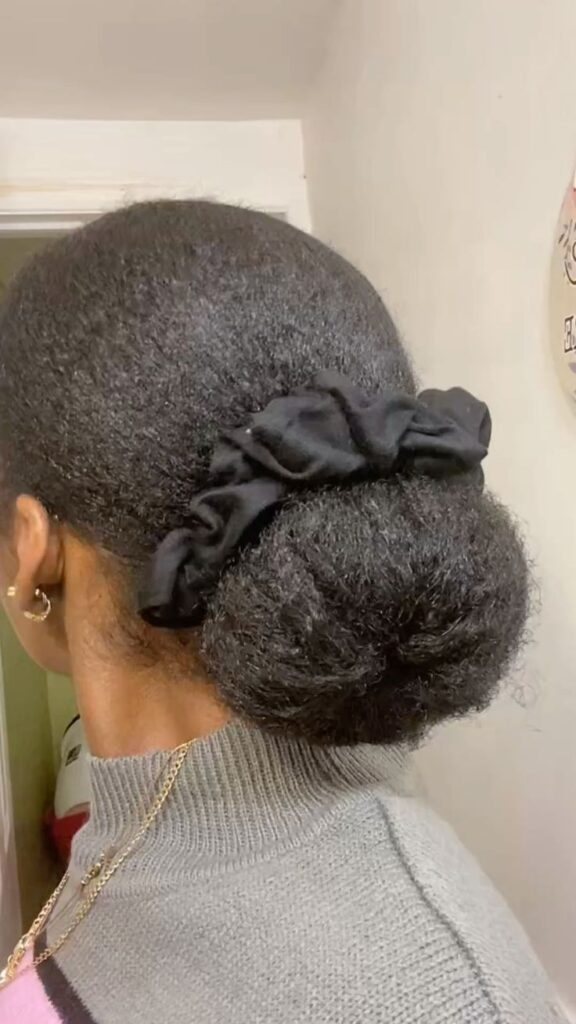 Natural 4C hair styled into a low bun