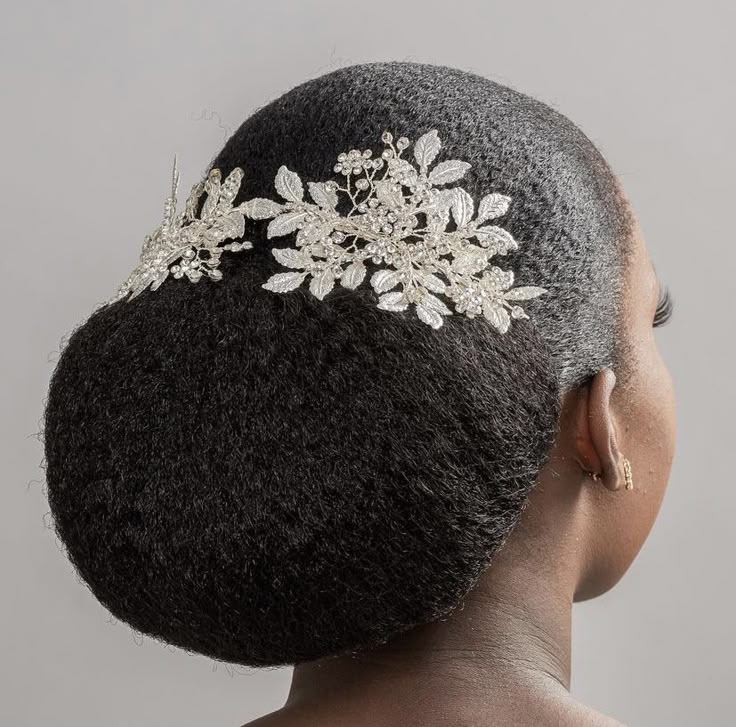 Natural hair styled into an elegant low chignon for a wedding