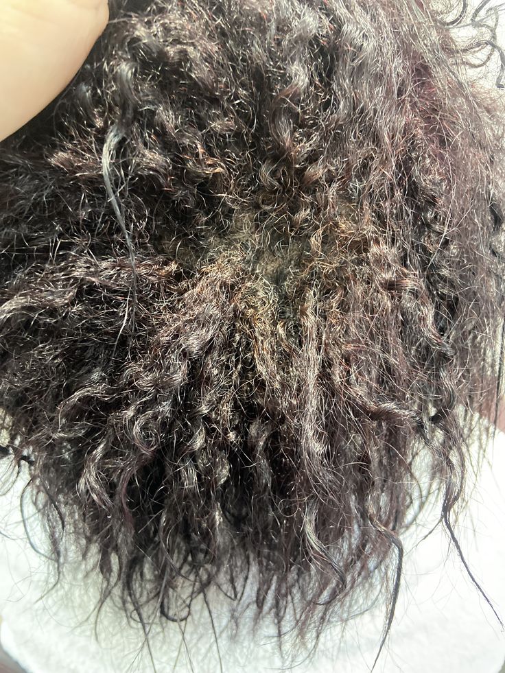 Low-porosity 4C hair showing visible product buildup before washing.