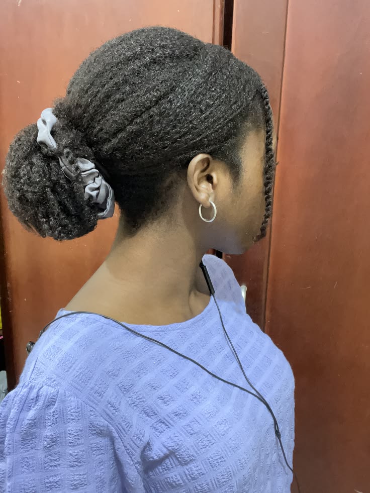 Natural 4C hair styled in a cute low textured bun