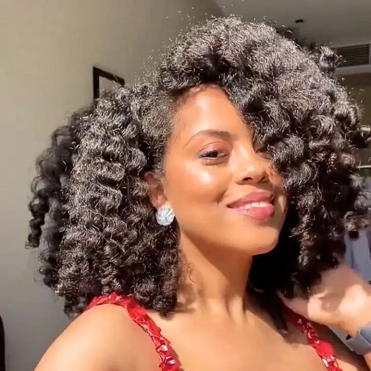 Medium-porosity 4C hair styled into a defined twist-out.