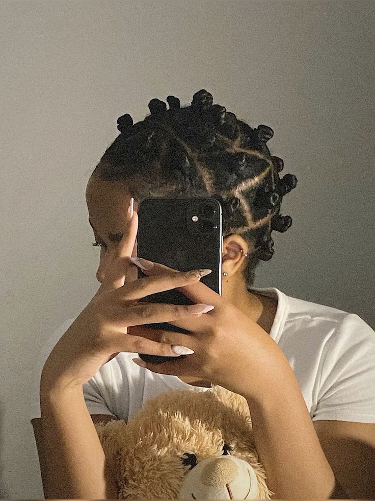 Natural 4C hair styled into cute small Bantu knots