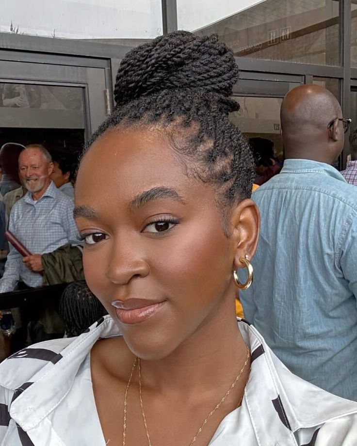 Mini twists styled into a bun on natural 4C hair