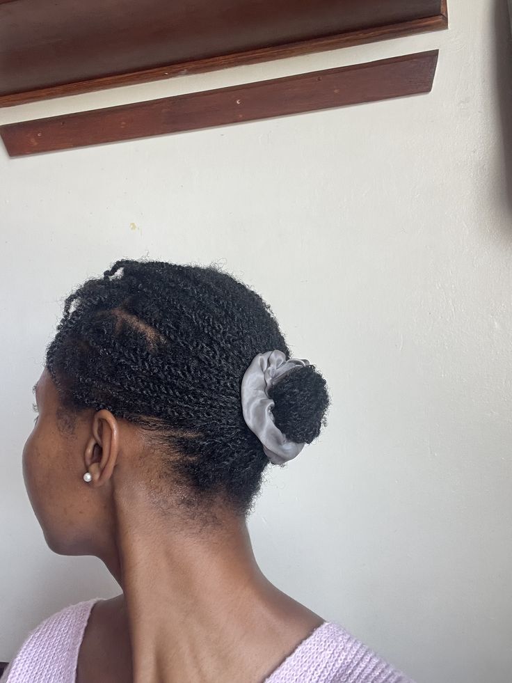 Mini twists styled into a bun on natural 4C hair