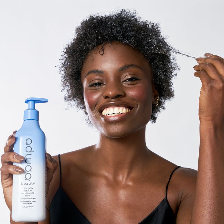 Applying moisturizer to healthy medium-porosity 4C hair.