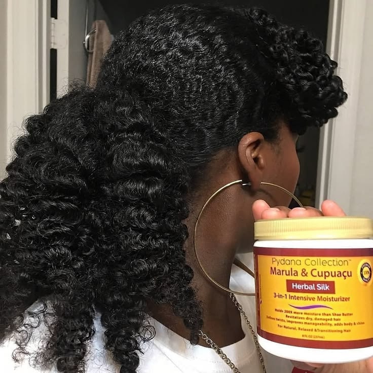 Moisturizer being applied to freshly washed natural hair