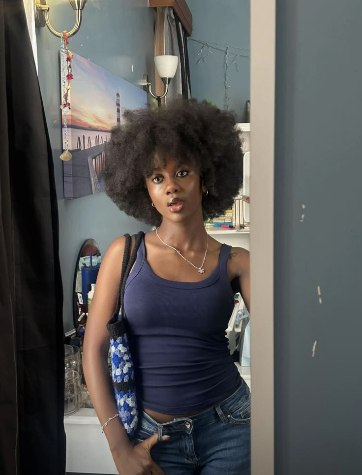Black woman proudly wearing her natural 4C hairstyle