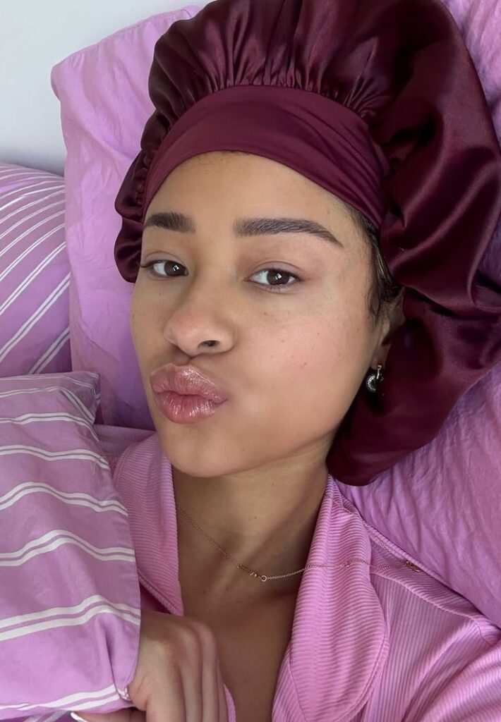 Woman protecting high-porosity 4C hair with a satin bonnet.