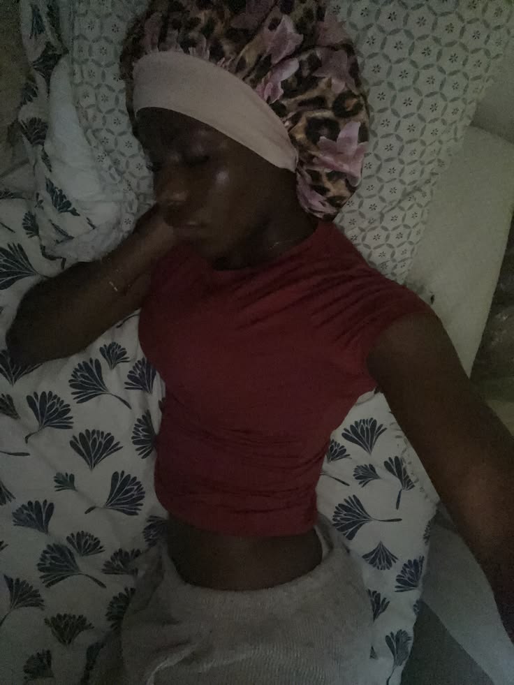  woman sleeping comfortably in a satin bonnet to protect hair overnight