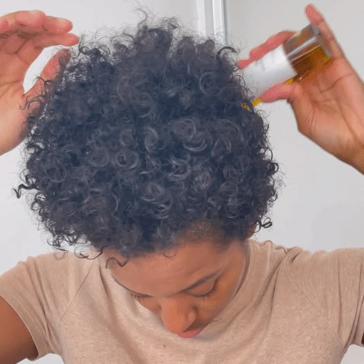 woman applying oil to hair  before shampooing