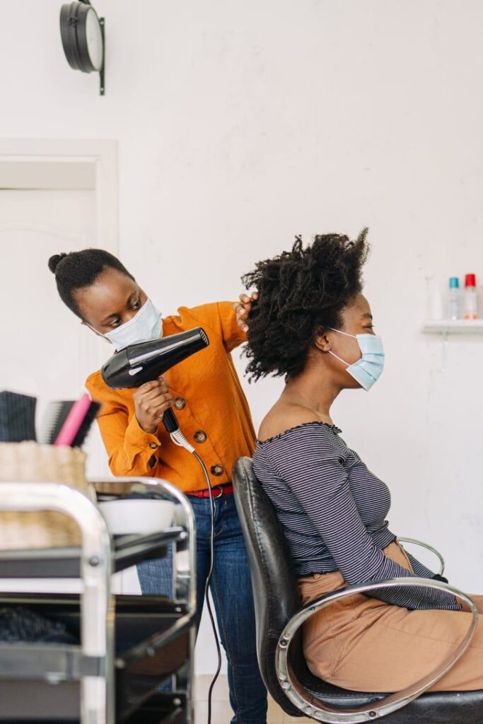 a woman preparing her hair before loc installation
