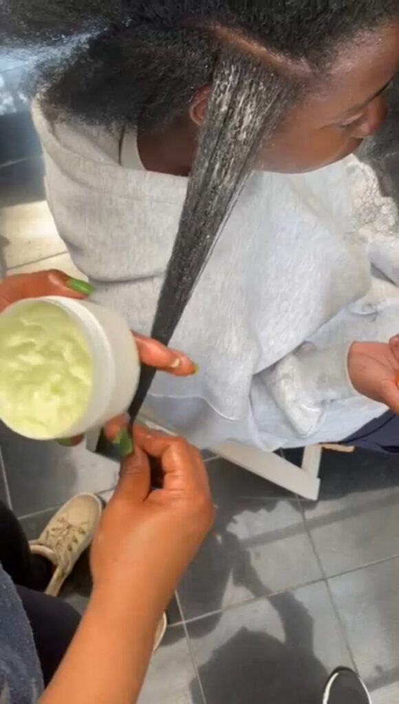 Protein treatment being applied to natural 4C hair