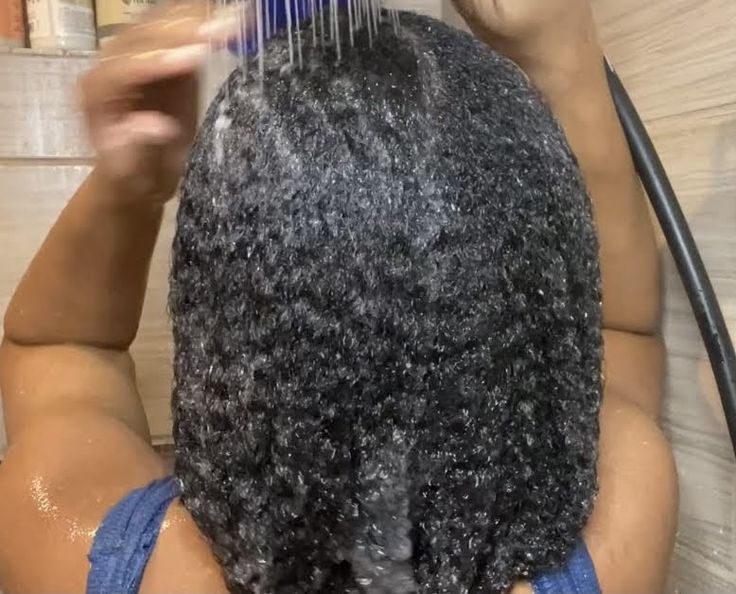 woman rinsing hair mask out of her hair