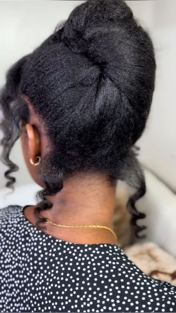Elegant rolled updo on natural 4C hair