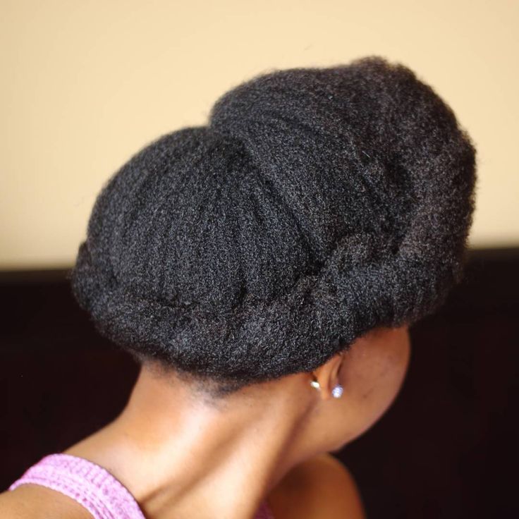 Asymmetrical rolled updo on natural 4C hair