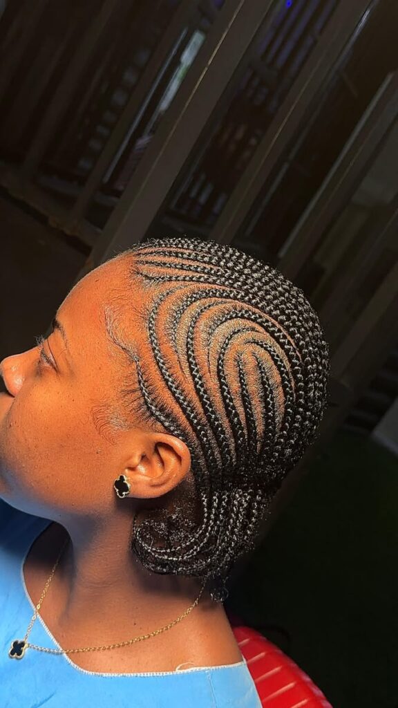 A woman wearing a protective style with a healthy-looking scalp.