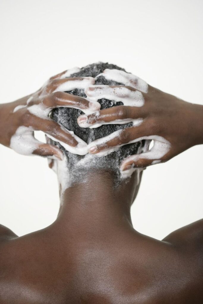 Woman gently shampooing 4C natural hair