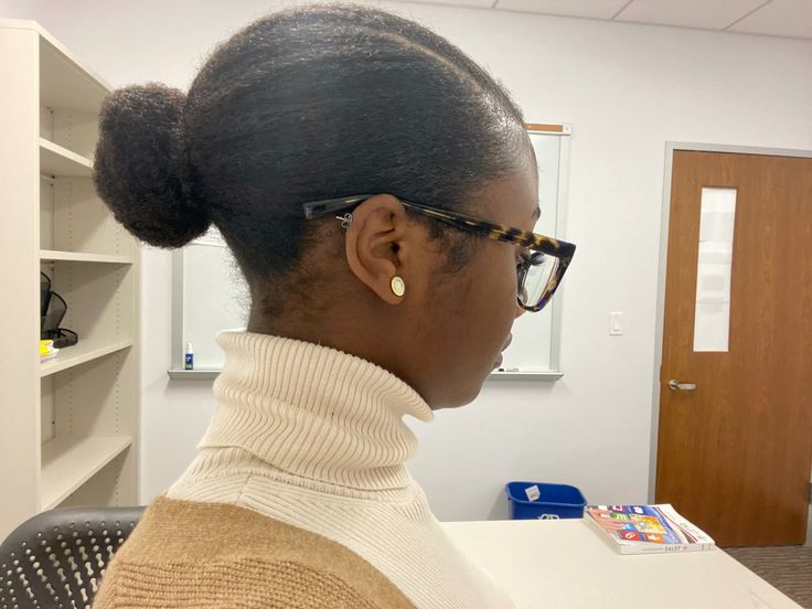 Natural 4C hair styled into a side bun