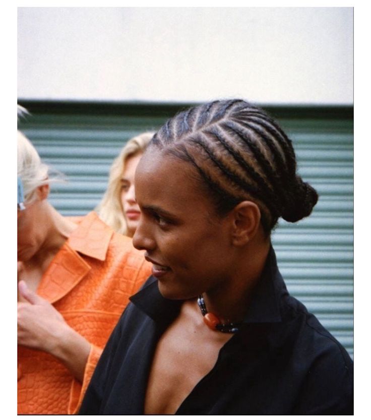Natural 4C hair styled with diagonal side cornrows