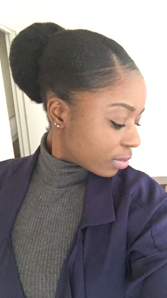 Natural 4C hair styled into a side-parted bun