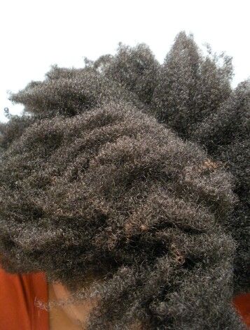 a hair showing Signs of product buildup in natural hair