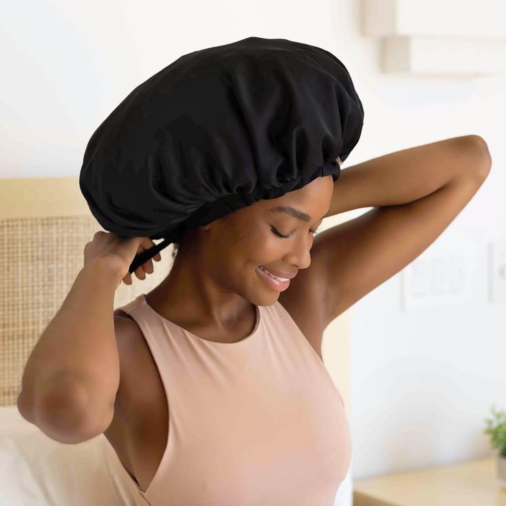woman wearing a satin bonnet to protect her starter loc before going to sleep