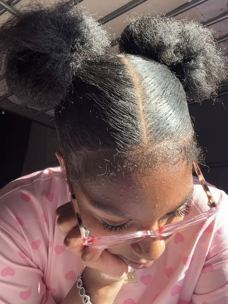 Natural 4C hair styled into cute two space buns